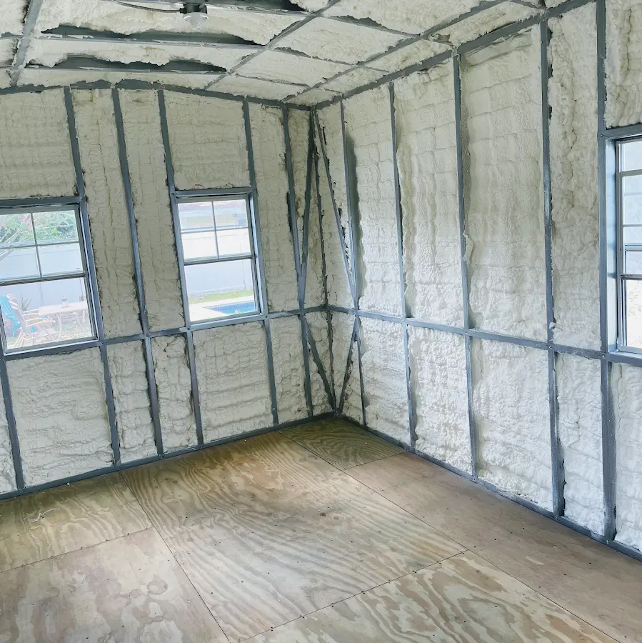 Closed-cell spray foam insulation applied to wall cavities in a residential project in Kasson